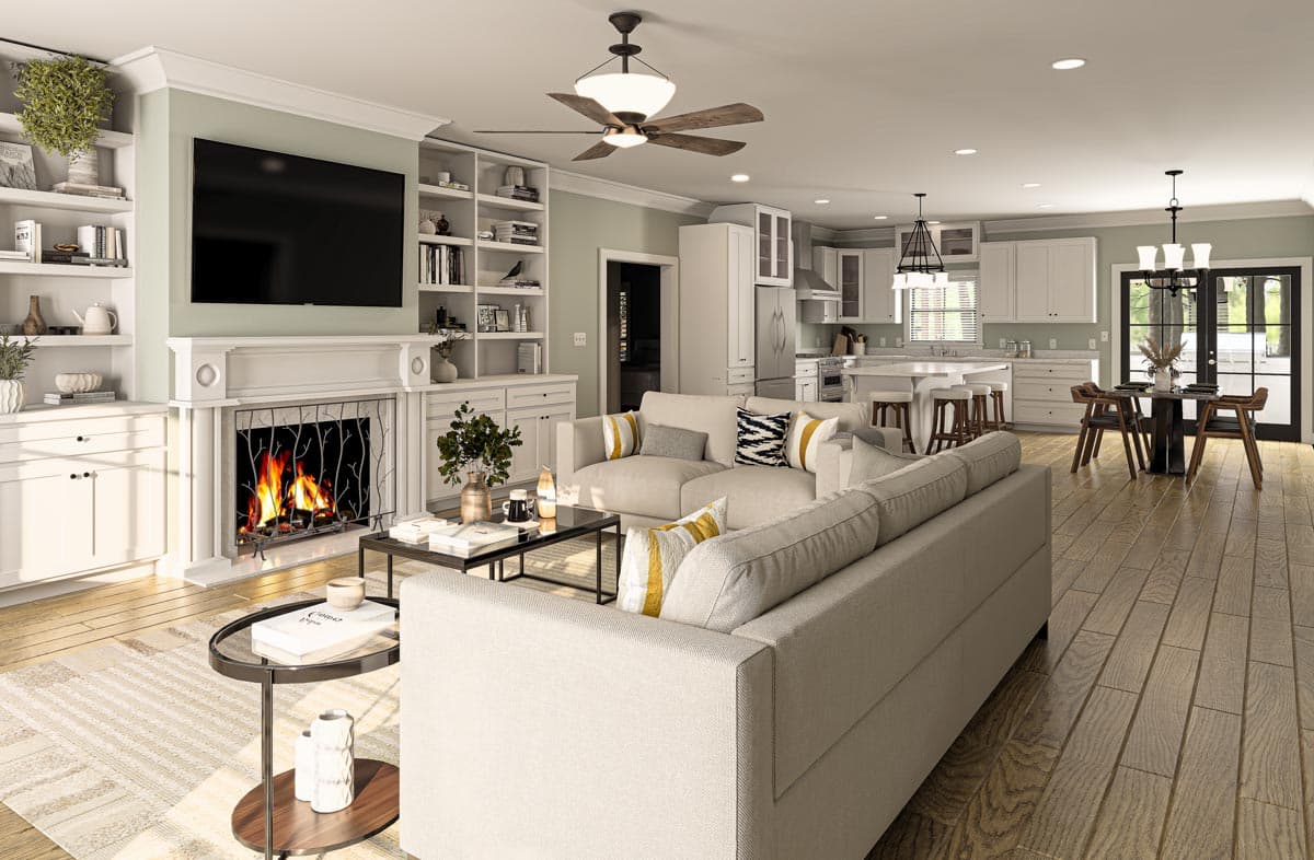Great room with fireplace, built-in shelving, sofa, island kitchen, and dining area. Open layout.