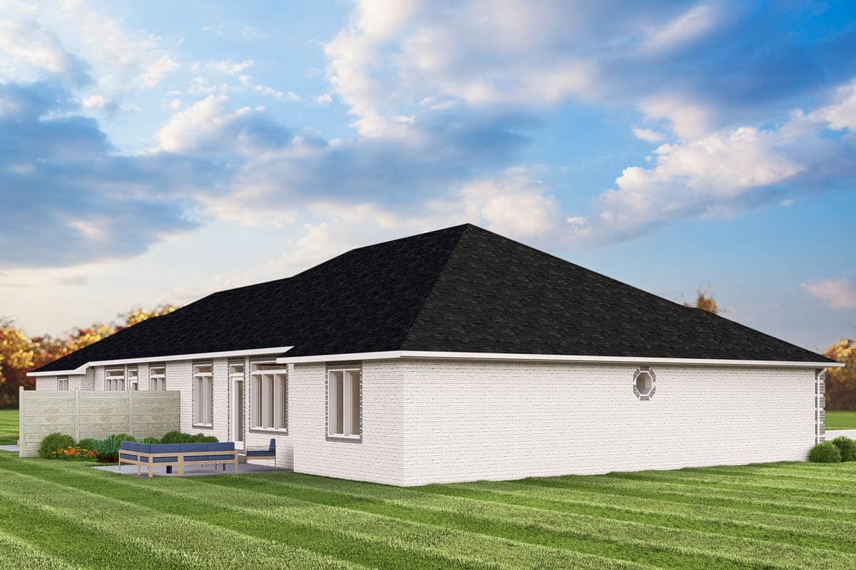 Ranch house plan exterior with white brick, a hipped roof, and a round accent window.