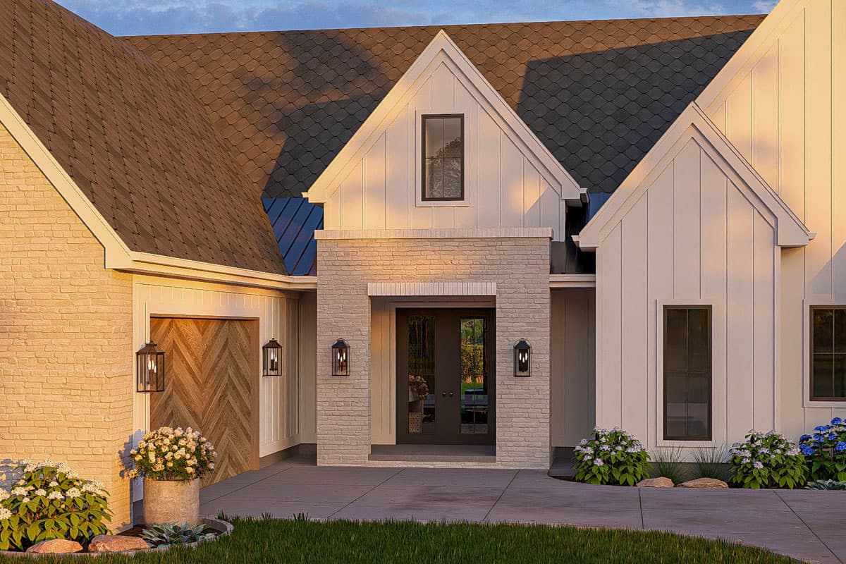 Modern Farmhouse house plan exterior with brick entrance, gabled dormer, chevron garage door, and multiple rooflines.