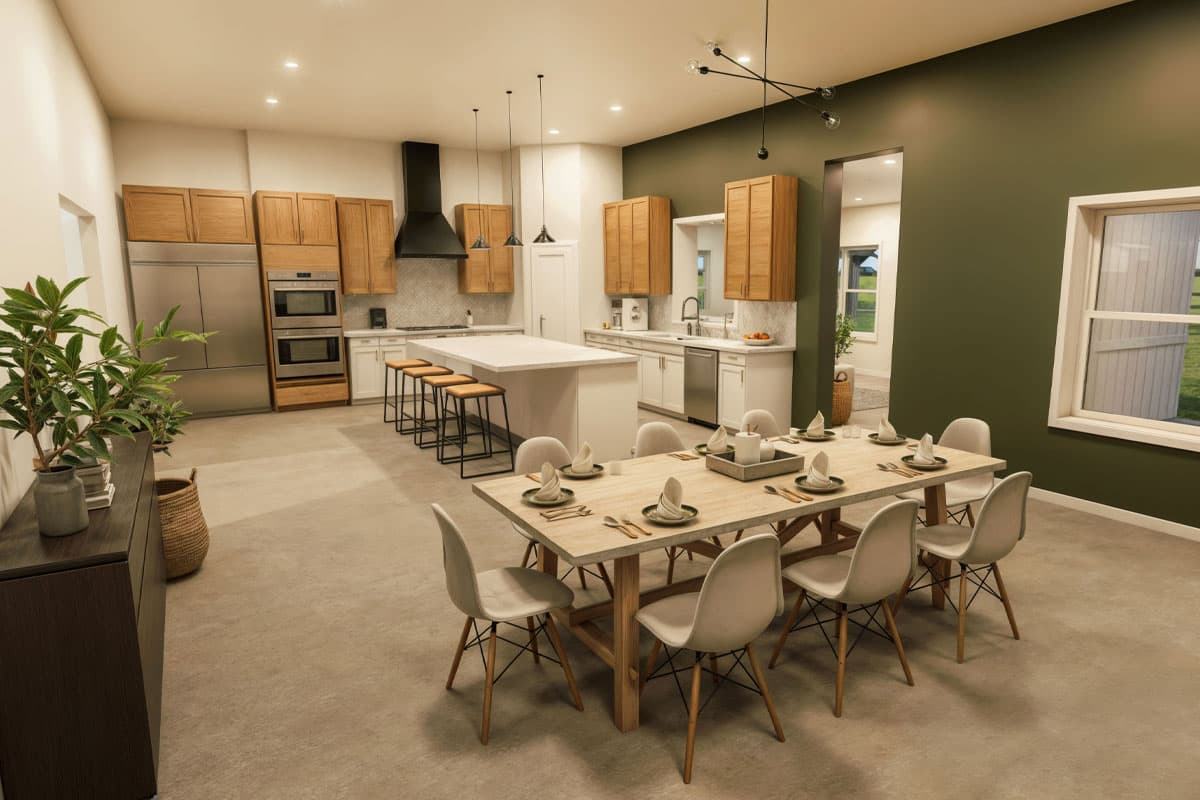 Open-concept dining and kitchen area with wood cabinetry, large island, stainless steel appliances, and a dining table for eight.