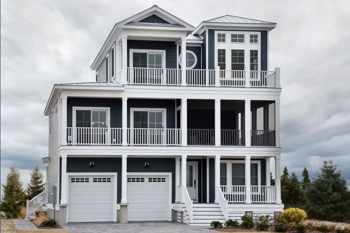 House plan exterior. Three-story coastal style home with multiple balconies, a covered porch, and a two-car garage. Features a cupola.