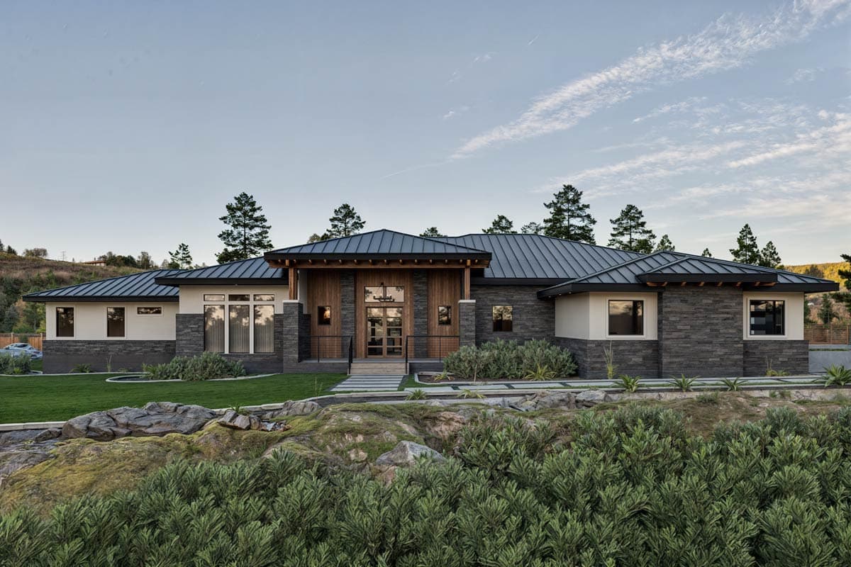 Modern house plan exterior with stone and wood siding, metal roof, and covered entry with glass doors.