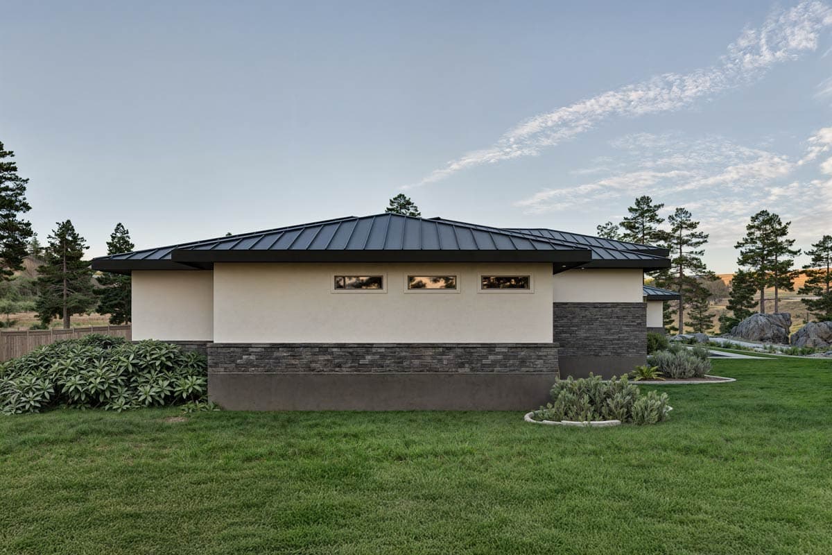 Modern single-story house plan exterior with metal gable roof, stucco siding, and stone base.