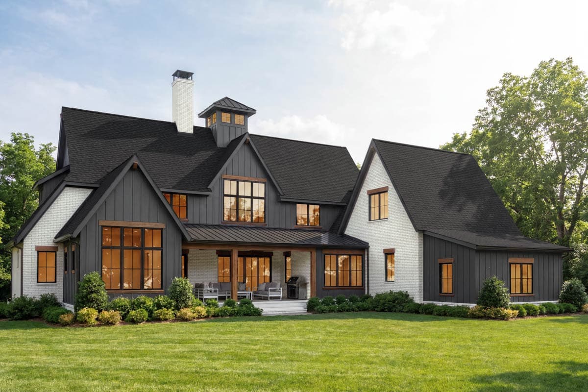 House plan exterior rendering showing a Modern Farmhouse style, two-story home with a prominent chimney, gables, and a covered porch.