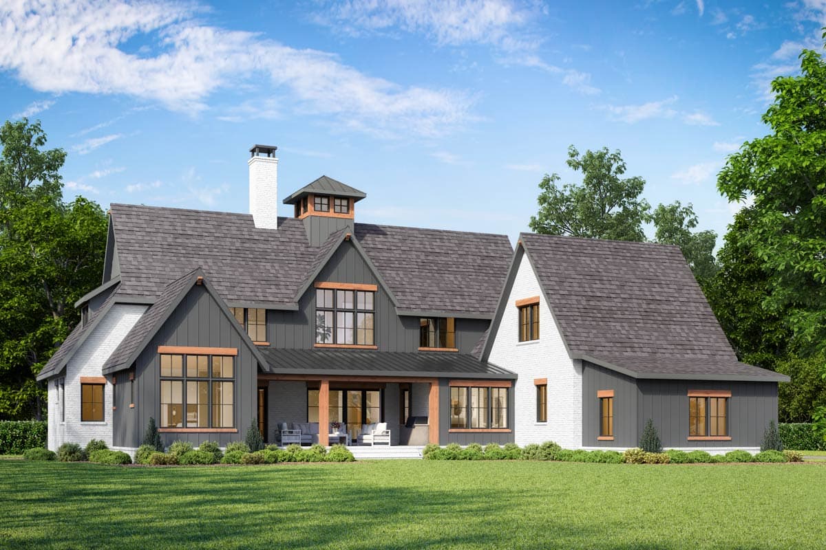 House plan exterior rendering showing a Modern Farmhouse style, two-story home with a prominent chimney, gables, and a covered porch.
