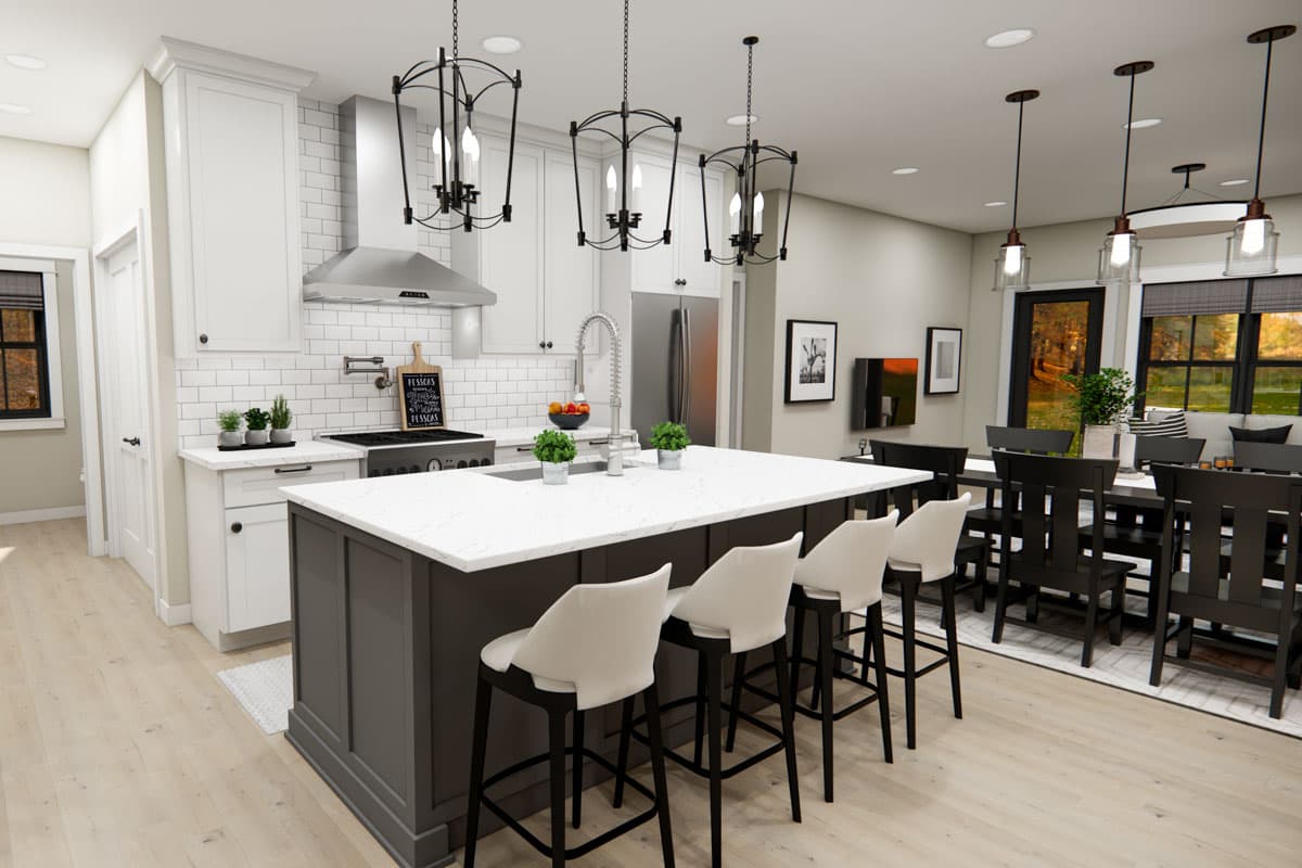 Contemporary kitchen with island, white subway tile backsplash, stainless steel appliances, and adjacent dining area.