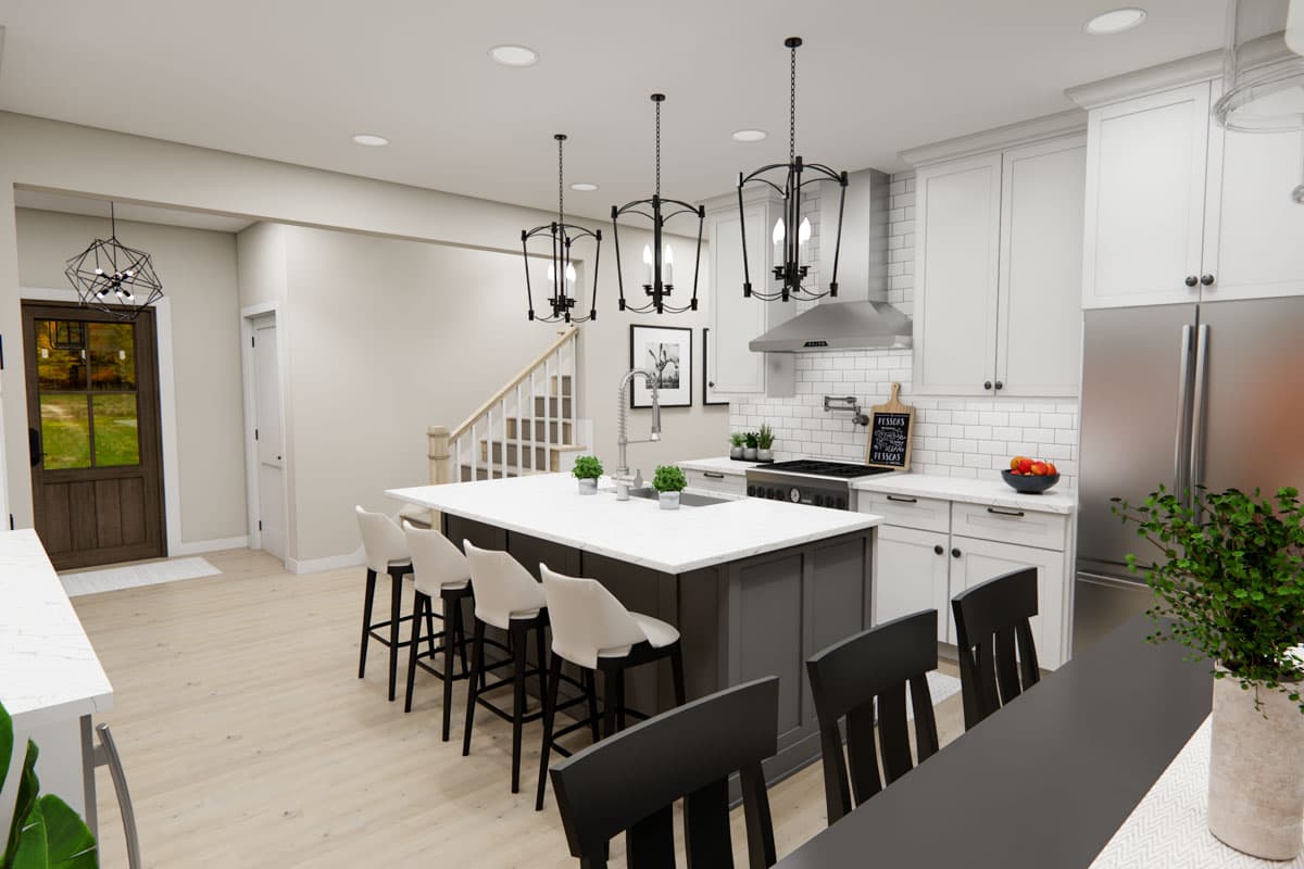 Kitchen with island, pendant lights, white subway tile backsplash, and stainless steel appliances.
