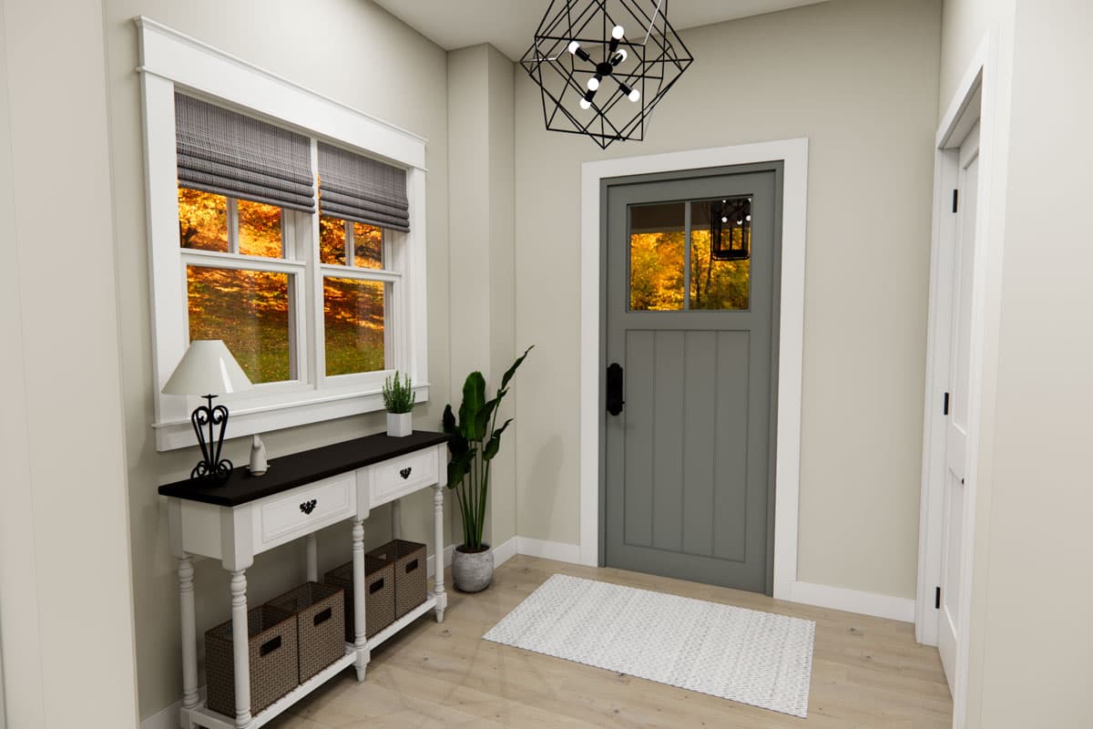 Entryway view with gray paneled door, window with autumn foliage view, console table, and geometric chandelier.
