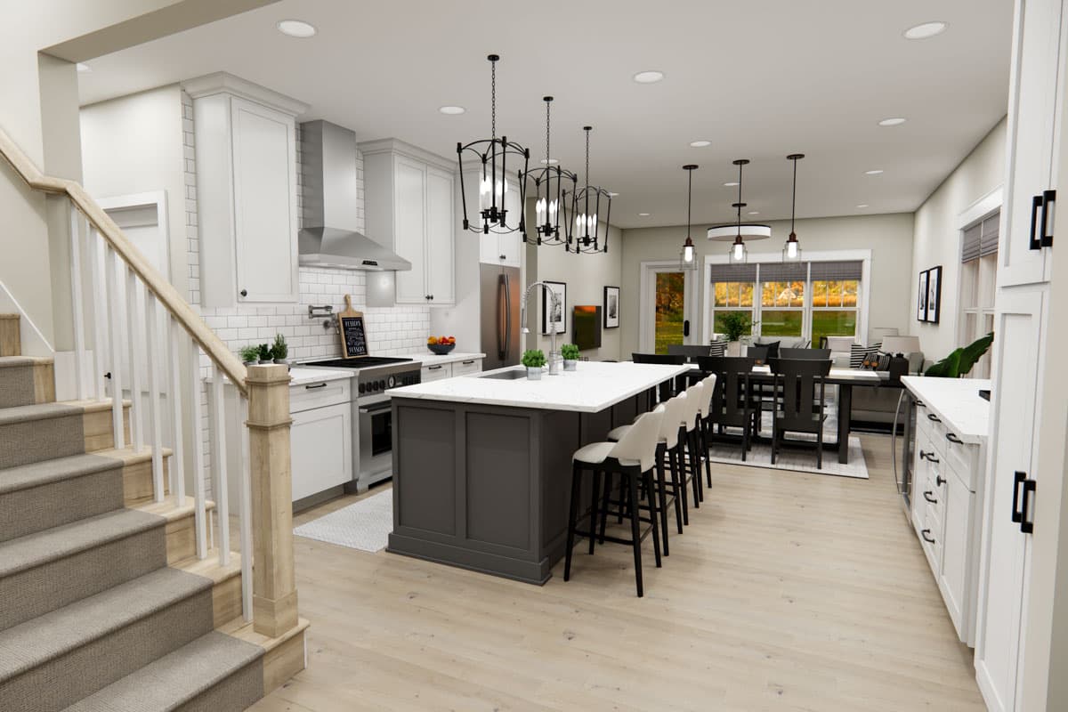 Open concept kitchen and dining area with island, range, pantry, and stairs.