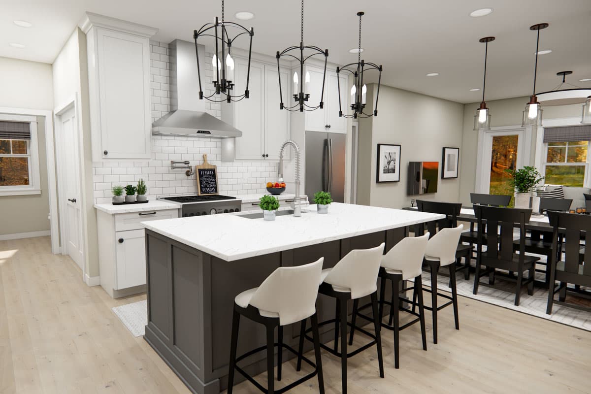 Kitchen with island, white subway tile backsplash, stainless steel range hood, and pendant lights. Adjacent dining area with dark wood table.