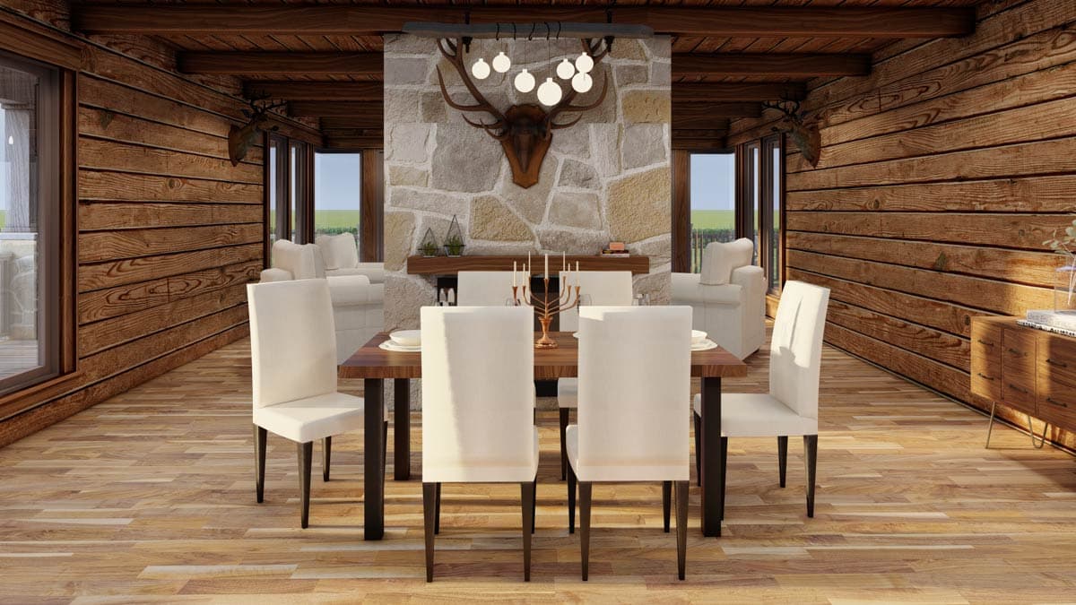 Dining room with log walls, stone fireplace with elk mount, and wooden table with white chairs.
