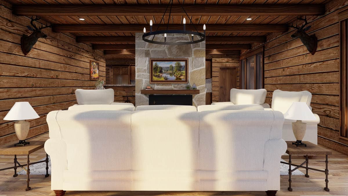 Interior view of a living room with log walls, a stone fireplace, vaulted wood beam ceiling, and sectional sofa.