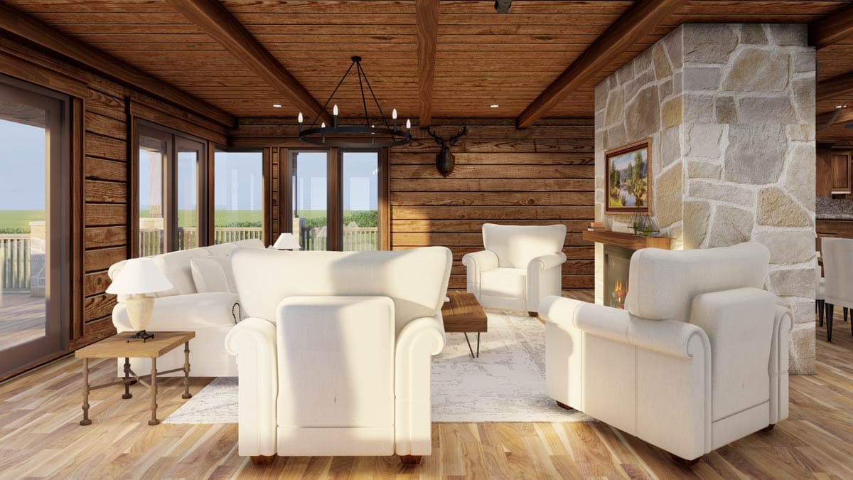 Log cabin interior living room with stone fireplace, wood-paneled walls, vaulted beamed ceiling, and large windows.