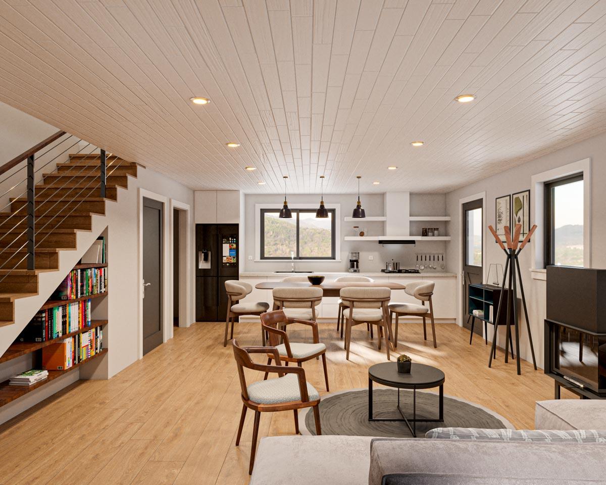 Open concept living area with staircase, kitchen island, dining area, and fireplace.