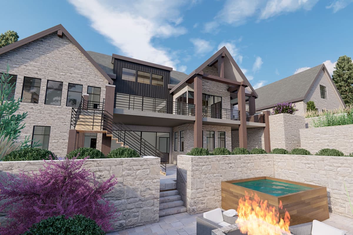 House plan exterior: stone, multiple gables, balconies, and an outdoor spa.