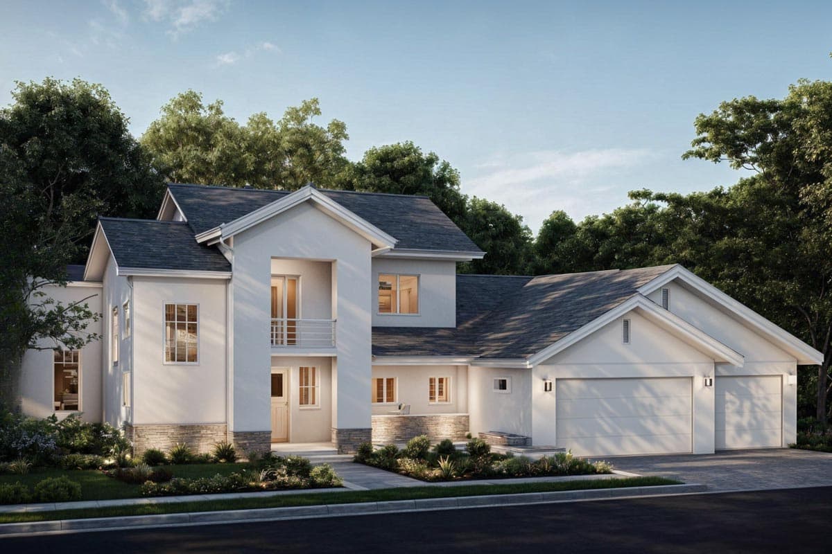 A modern, two-story house with a white facade and dark grey roof is surrounded by lush greenery, including trees and manicured gardens.