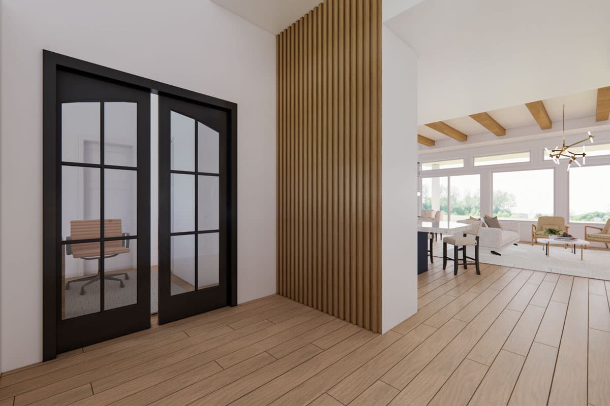 Interior view of a house with black paneled doors, a slatted wood accent wall, and an open living area with large windows and exposed beams.