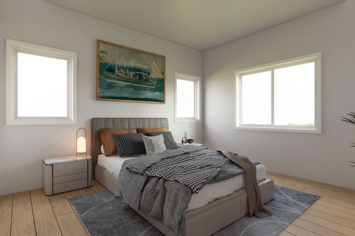 Primary bedroom with a queen-size bed, three windows, and framed artwork above the headboard.