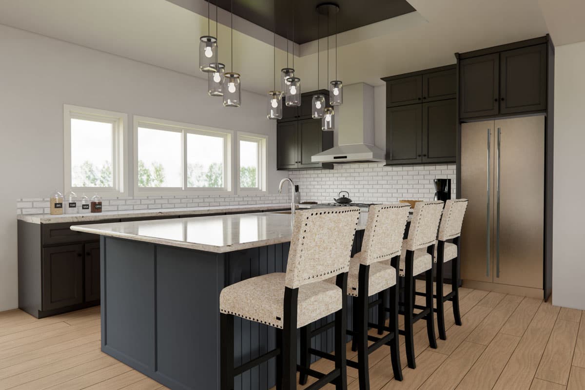 Kitchen interior with island, pendant lights, stainless steel appliances, white subway tile backsplash, and large windows.