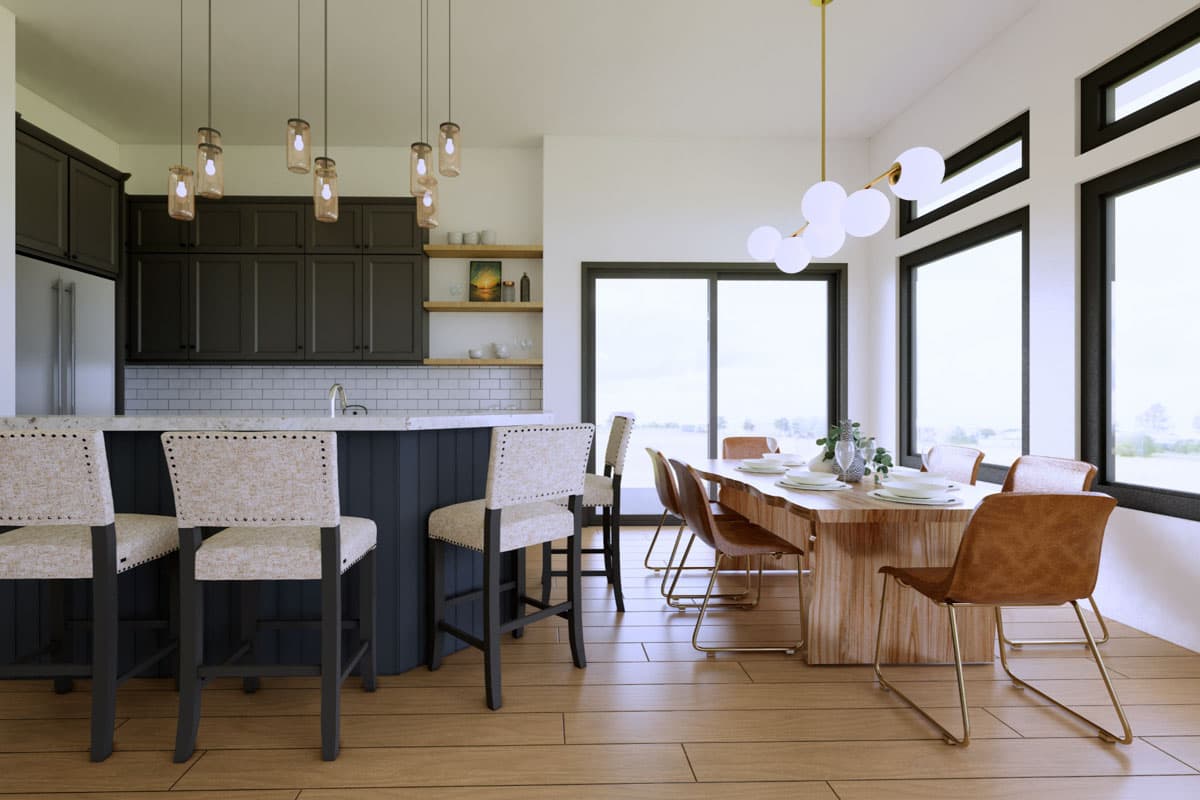 Kitchen and dining area with dark cabinets, island with bar stools, wood table, and large windows.