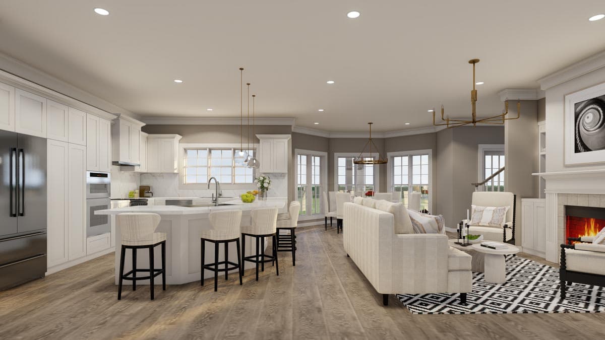 Open concept living space with kitchen island, dining area, and fireplace.