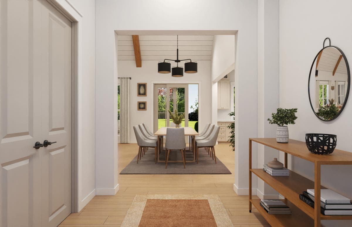 Dining room with vaulted ceiling, exposed beam, chandelier, and french doors. Hallway with double doors and console table.