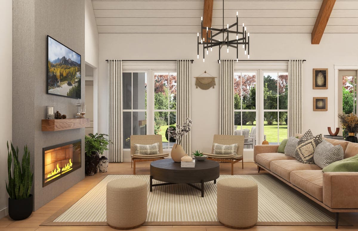 Great room with vaulted ceiling, exposed beams, fireplace, and large windows overlooking a garden.