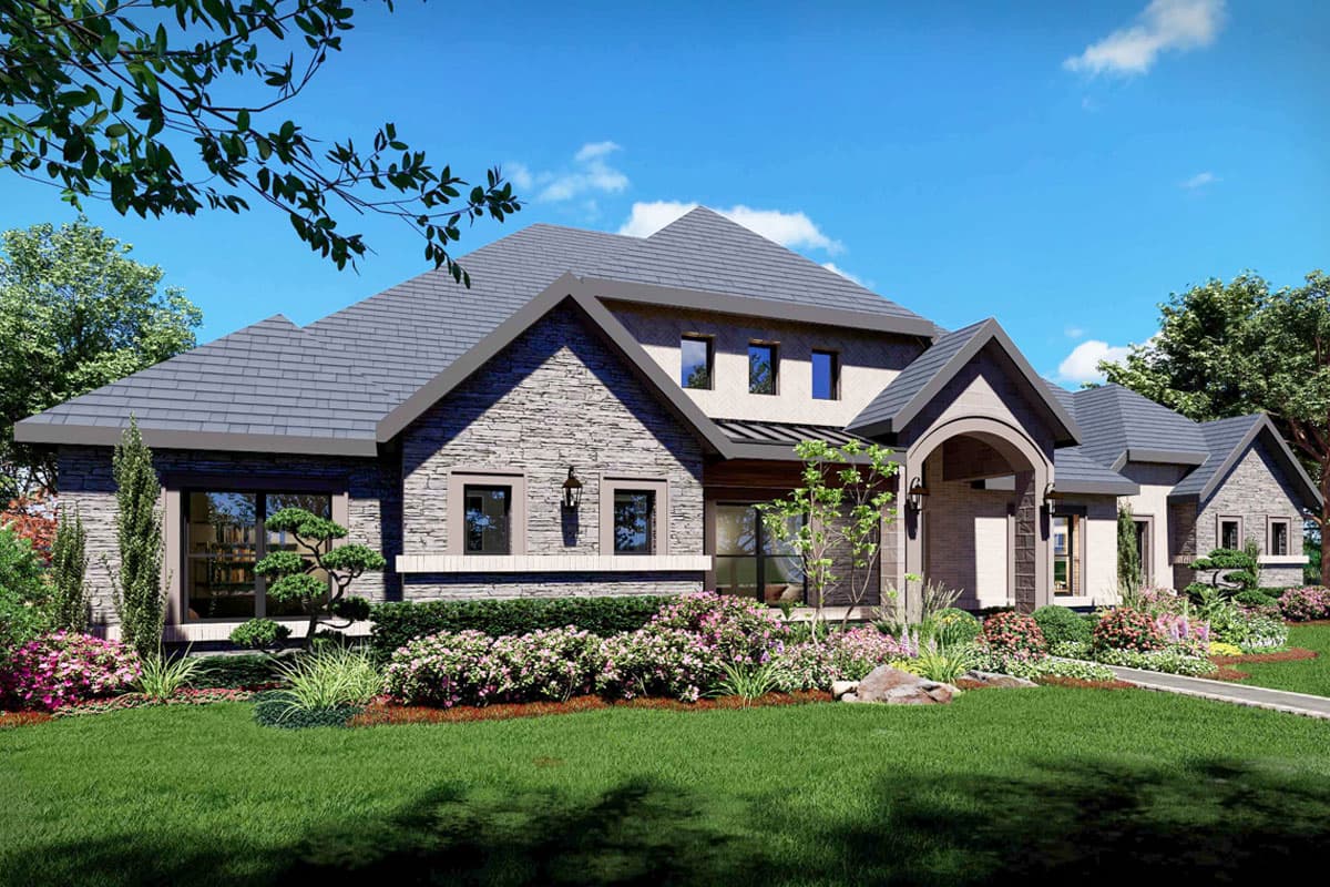 House plan exterior: Large two-story home with stone facade, multi-level roof, arched entry, and diverse window placements.