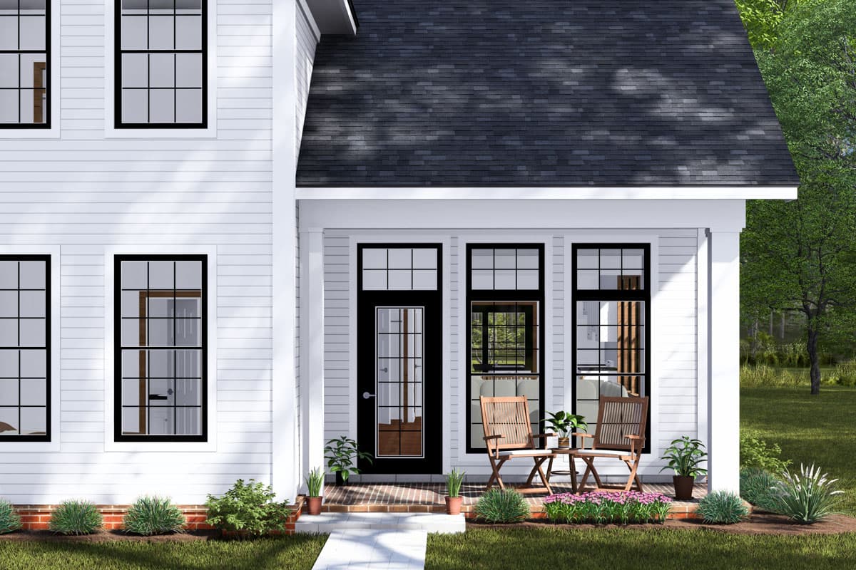 Modern farmhouse house plan exterior with white siding, gabled roof, central porch with black door and multi-pane windows.