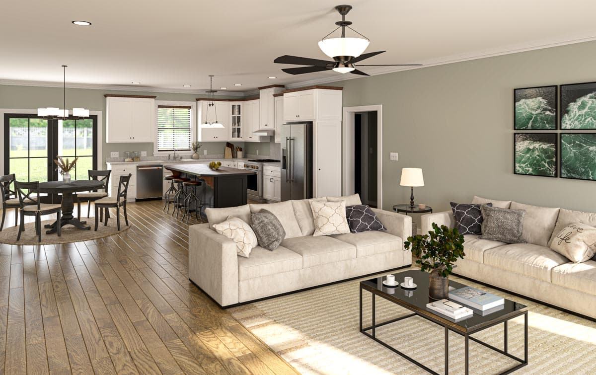 A modern, open-concept living space with a kitchen. The room features a living area with a sofa, and a dining area with a round table.