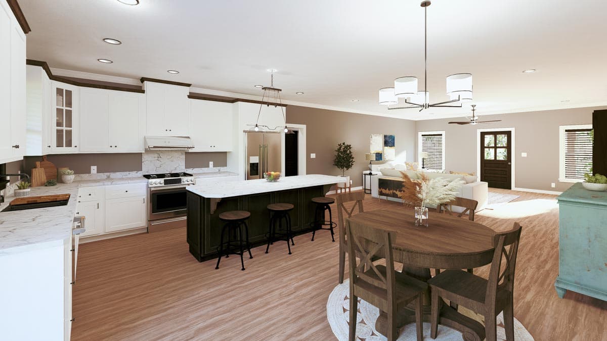 Spacious, open-concept kitchen and living area, featuring a white and dark green island with stools, dining table, and cozy living room.