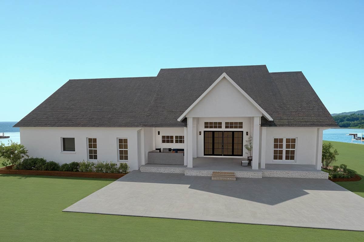House plan exterior: One-story Modern Farmhouse with covered entry, gable roof, large glass doors, and an adjacent outdoor living area.
