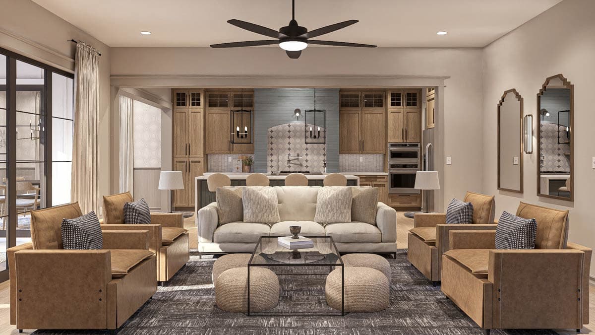 Open concept living area with neutral sofa, leather chairs, and kitchen with wood cabinetry and island.