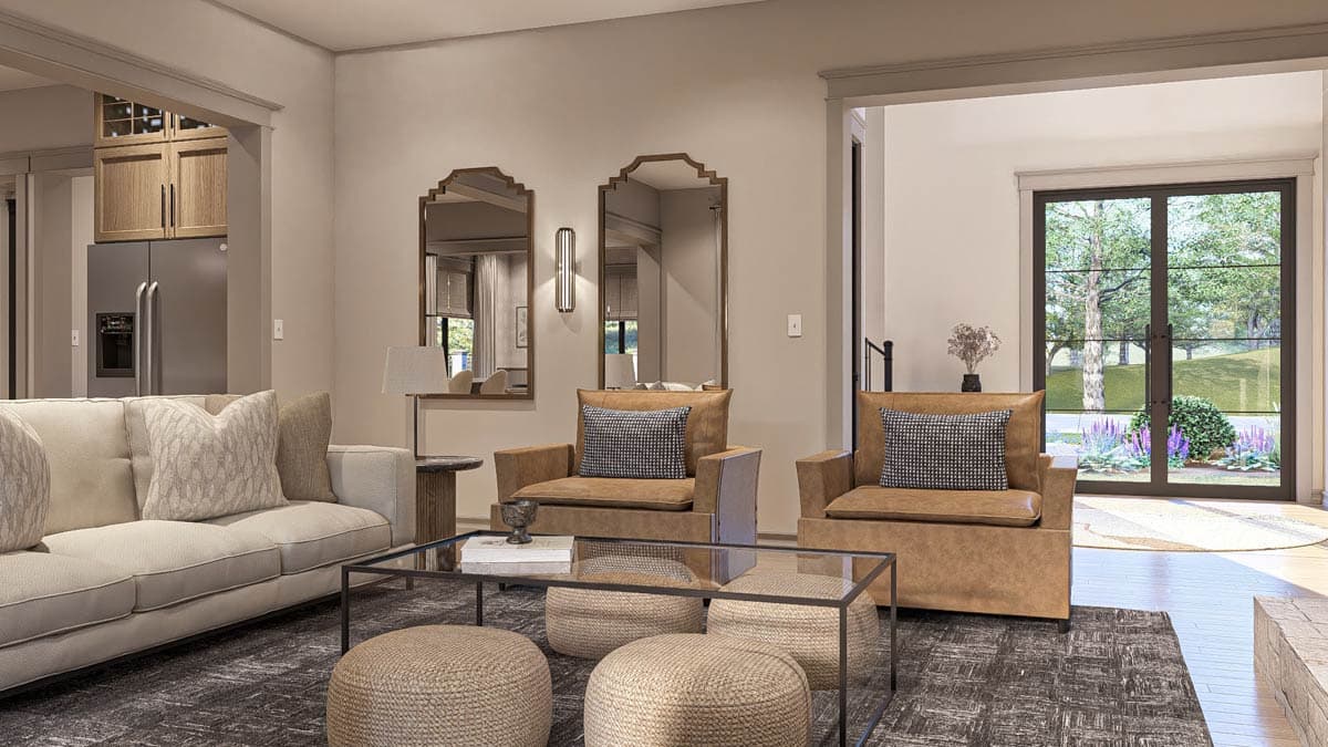 Interior view of a living area with a sofa, chairs, coffee table, and doors leading outside.