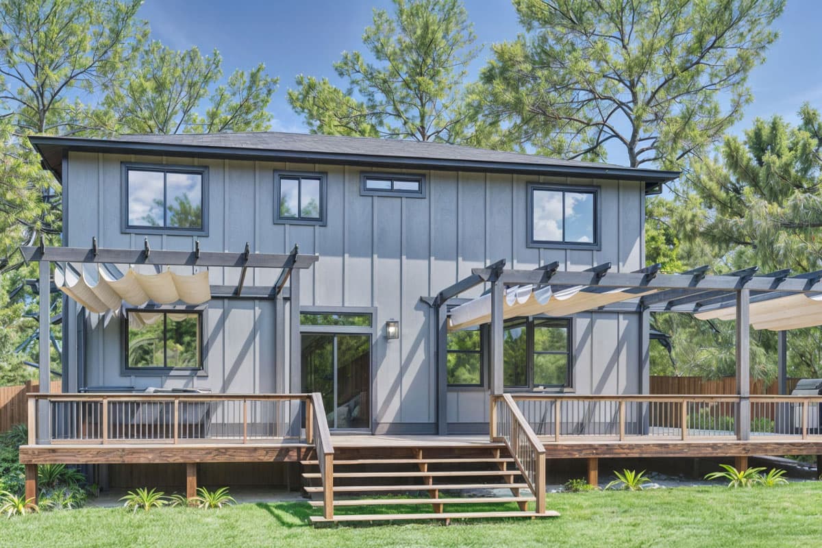 Modern two-story house plan exterior with vertical siding, prominent deck, and pergolas with retractable shades.