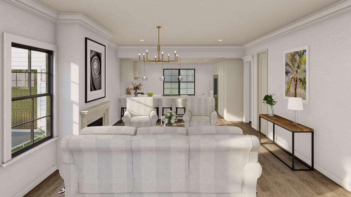 Open concept living area with fireplace, kitchen island, and view of the outdoors through a large window.