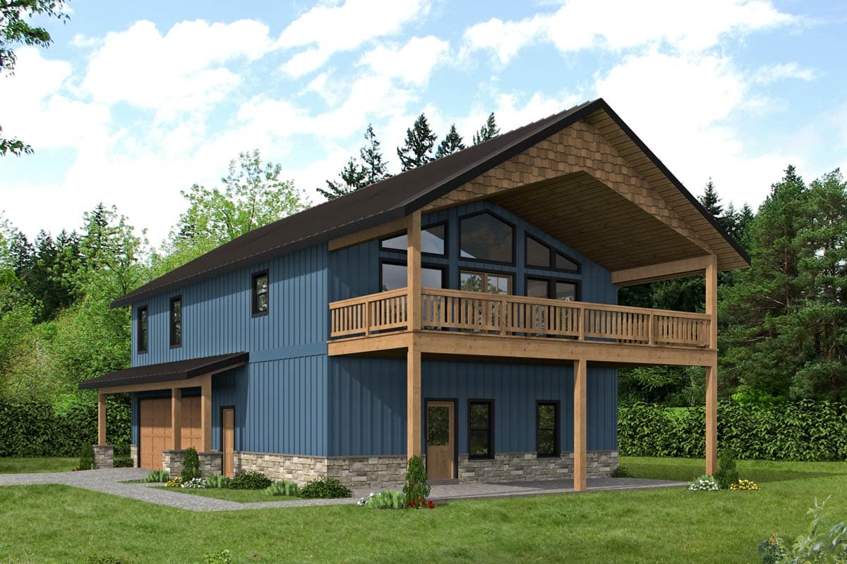 A modern two-story house with a blue exterior and a large balcony. The house features wooden accents, a dark roof, and sits in a green, wooded area.
