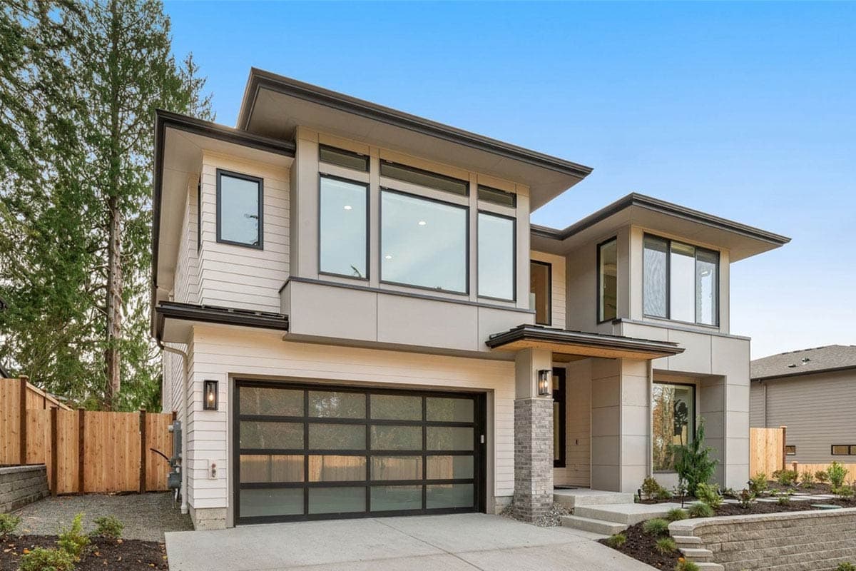 Modern two-story house plan exterior with horizontal siding, large windows, cantilevered rooflines, and glass garage door.