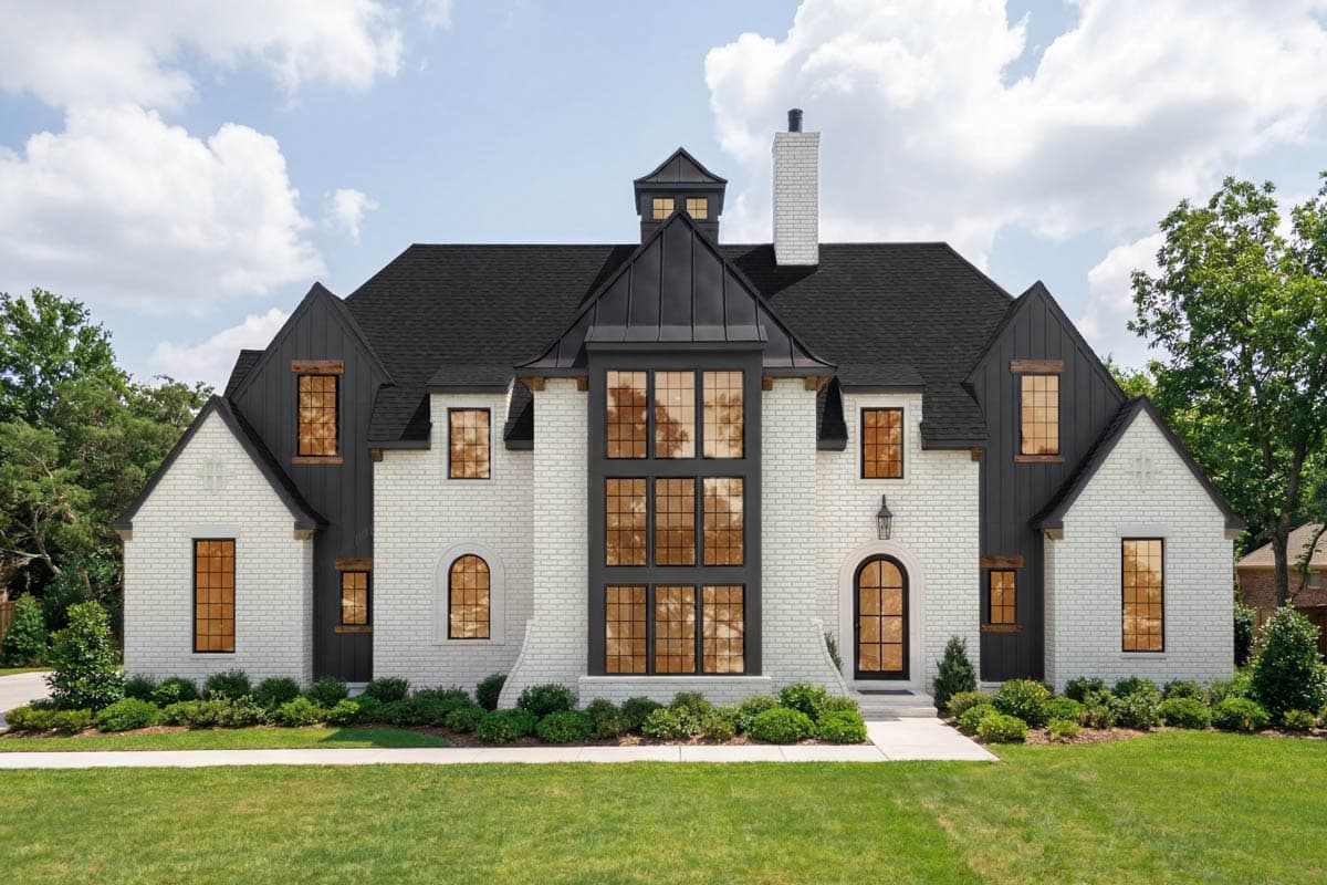 House plan exterior. Two-story with dark roof, multi-pane windows, dormers, and gabled rooflines. Includes a centered cupola and brick facade.