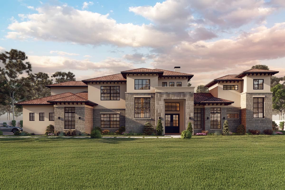 House plan exterior with two stories. Features include a stone facade, tile roof, and multiple gables. Large windows and a porte-cochère are visible.