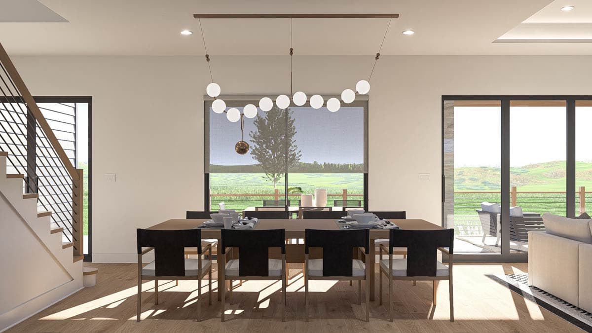 Dining room with open layout, modern staircase, large window with view, and patio doors.