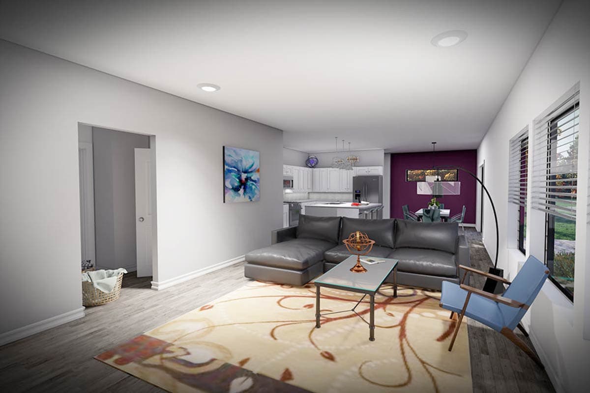 Living room and kitchen open concept with gray sectional sofa, glass coffee table, and island. Dining area with purple accent wall.