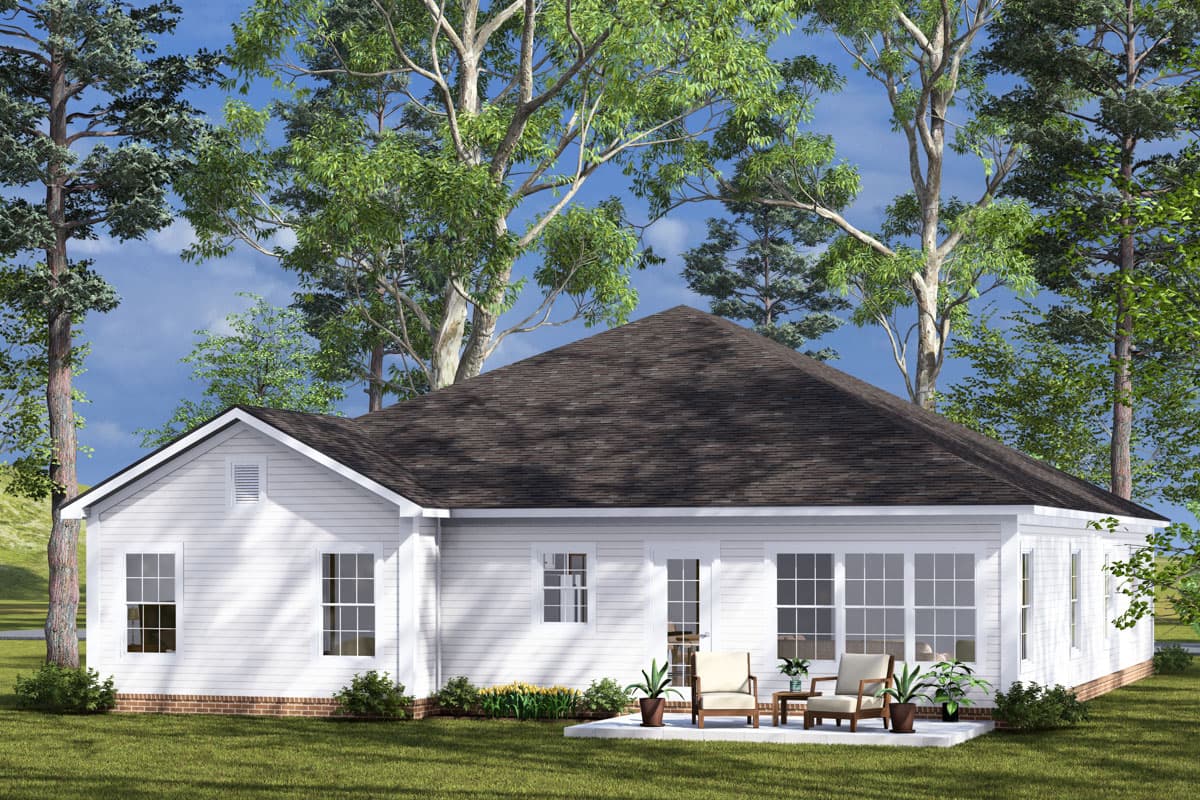 House plan exterior. Single-story ranch-style home with white siding, a prominent hipped roof, and a patio with chairs.