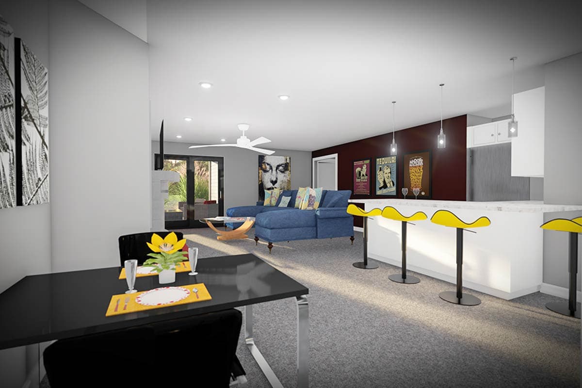 Open concept living space with dining area, sectional sofa, and kitchen island with bar stools.