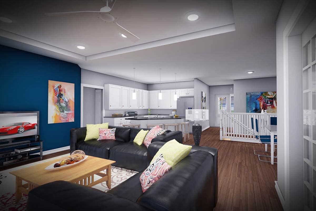 Open concept living area with kitchen island, sectional sofa, and staircase.