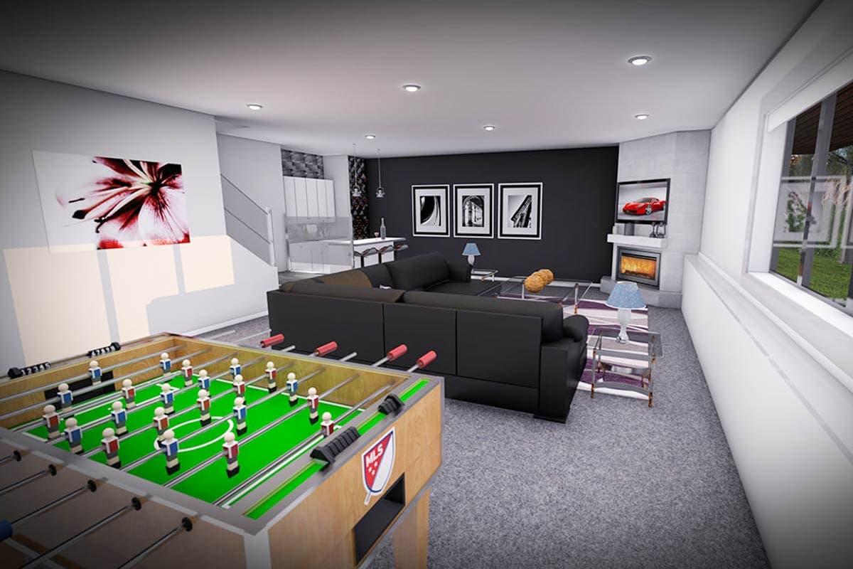 Open concept living space with foosball table, sectional sofa, fireplace, and kitchen area with island.