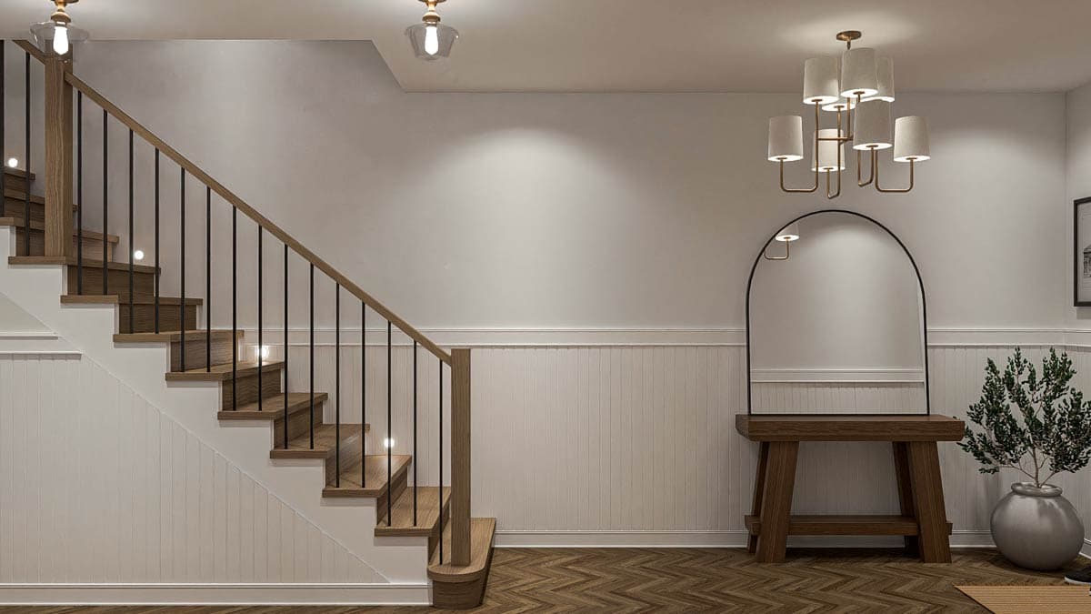 Interior view of a staircase with wooden treads, black spindles, and inset stair lights. Arch mirror and console table visible.