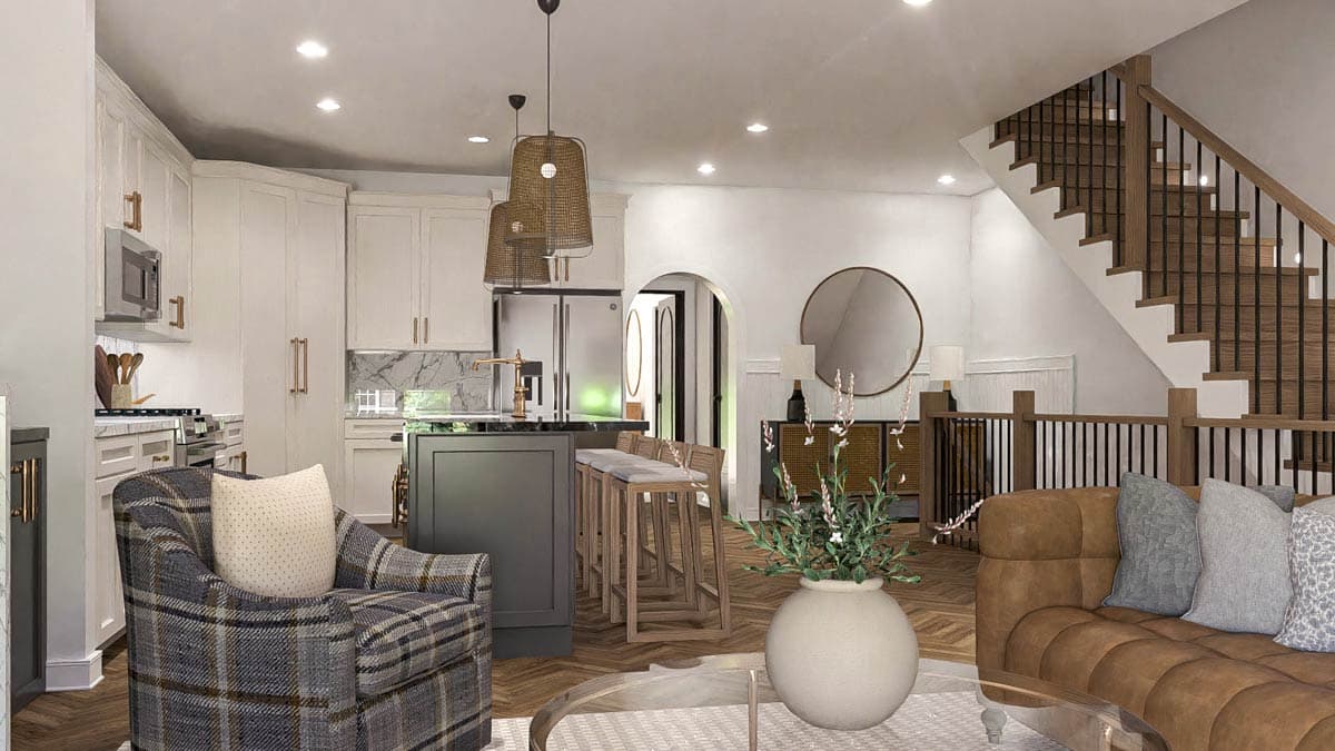 Open concept living area with kitchen island, white cabinetry, wood staircase with black railing, and seating.