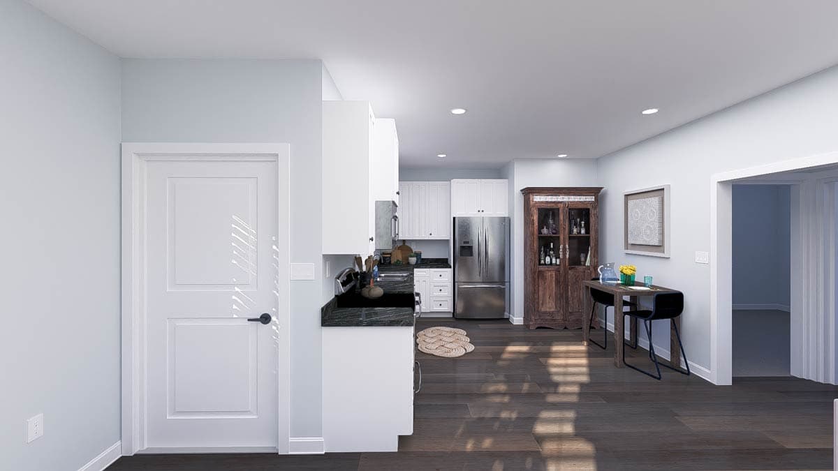 Interior rendering of a kitchen with white cabinets, stainless steel appliances, and a dark countertop. A small dining area is adjacent.