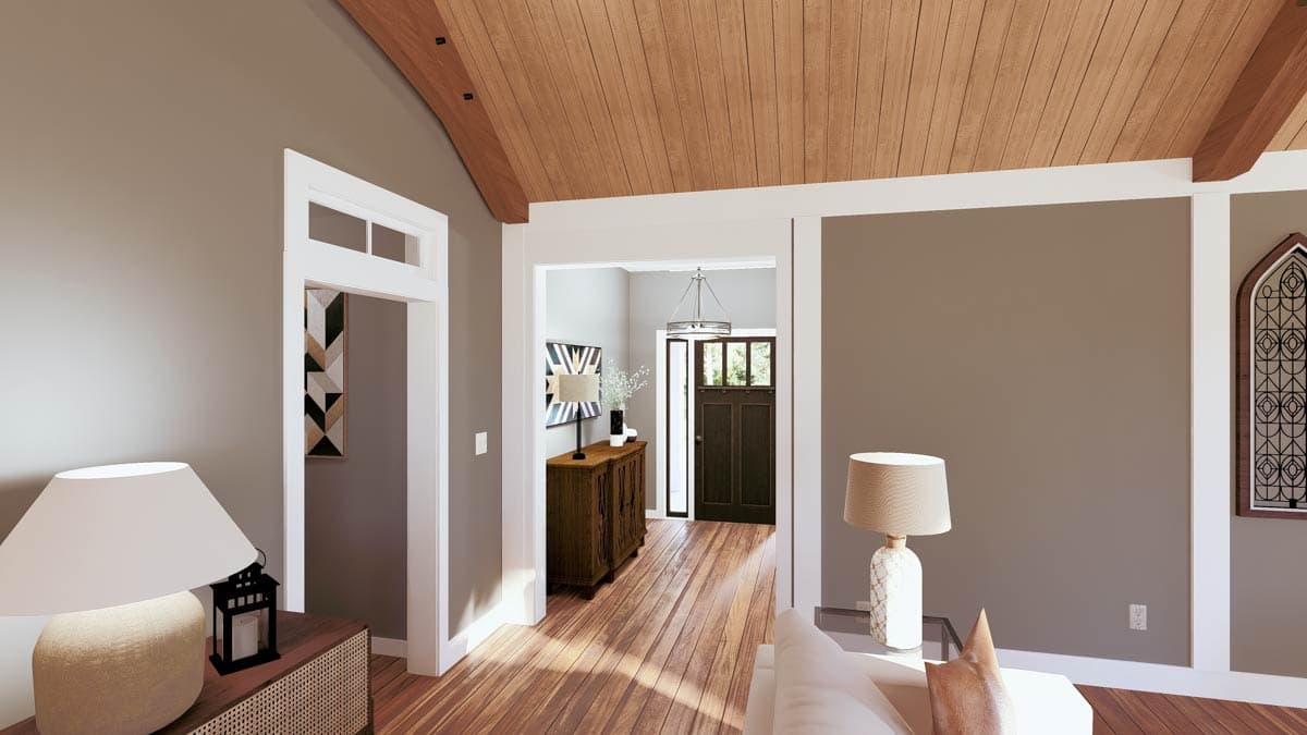 Interior view of a home with vaulted wood-paneled ceiling, entry hall with dark wood door, and decorative window.